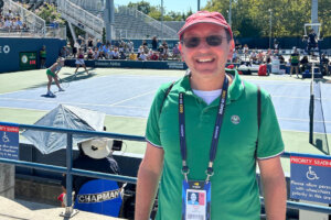 Freelance journalist Michael J. Lewis poses for a photo while covering the 2023 U.S. Open. (Courtesy: Michael J. Lewis)