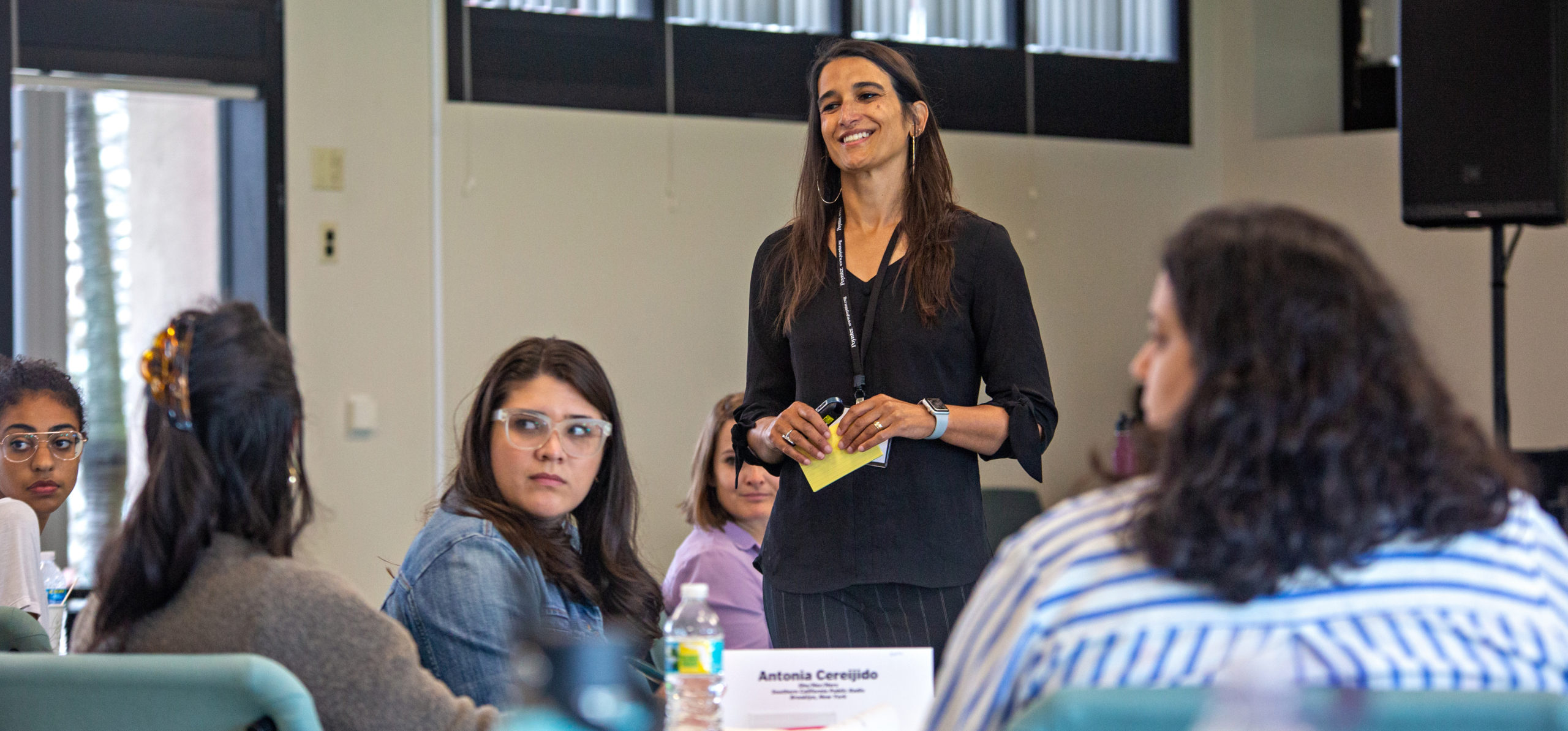 Poynter faculty Sitara Nieves stands in a Poynter classroom to teach diverse women about leadership.